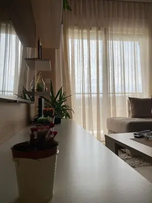 a living room with a table and a couch at Apartman DVA SRCA in Bar