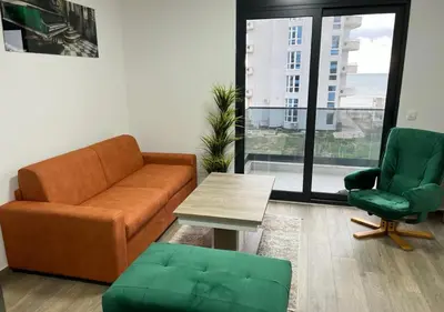 a living room with a couch and a table and a chair at Apartment SuSe in Dobra Voda