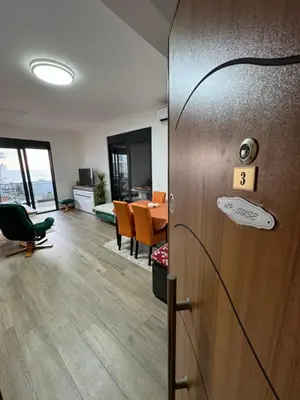 an office with a door and a room with a table at Apartment SuSe in Dobra Voda