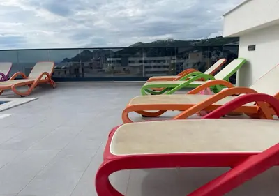a row of colorful chairs sitting on a roof at Apartment SuSe in Dobra Voda