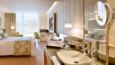 a hotel room with a bed and a sink at Maestral Resort & Casino in Budva