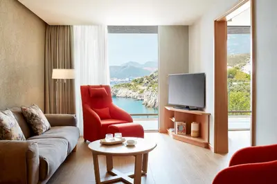 a living room with a couch and a tv at Maestral Resort & Casino in Budva
