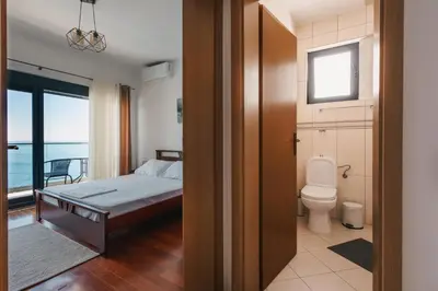 a bedroom with a bed and a toilet at Seafront Villa with Private Pool in Dobra Voda, Montenegro in Bar