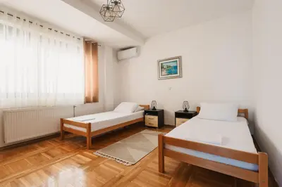 a bedroom with two beds and a window at Seafront Villa with Private Pool in Dobra Voda, Montenegro in Bar
