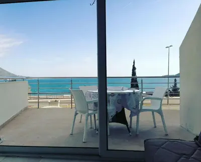 a table and chairs with a view of the ocean at One minute to the beach in Becici