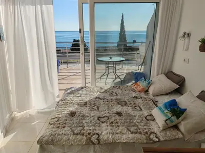 a bedroom with a bed and a view of the ocean at One minute to the beach in Becici