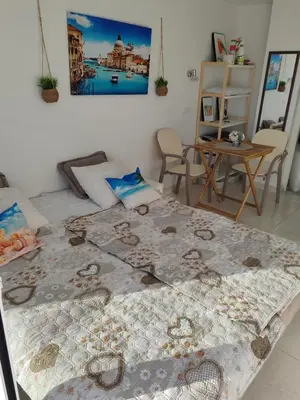 a large bed in a room with a table at One minute to the beach in Becici