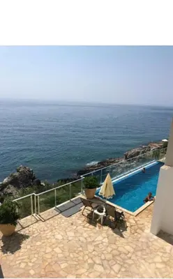 a swimming pool with a view of the ocean at Paradise beachfront view 2 in Dobra Voda