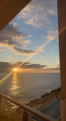 a view of the ocean at sunset from a balcony at Paradise beachfront view 2 in Dobra Voda