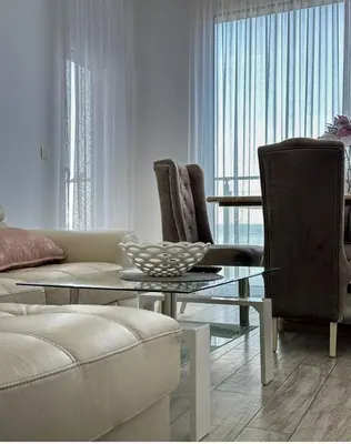a living room with a couch and a table and chairs at Paradise beachfront view 2 in Dobra Voda