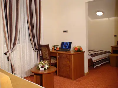 a room with a desk with a laptop on it at Mali Hotel BaMBiS in Podgorica