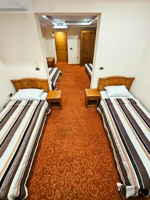 a row of three beds in a room at Mali Hotel BaMBiS in Podgorica