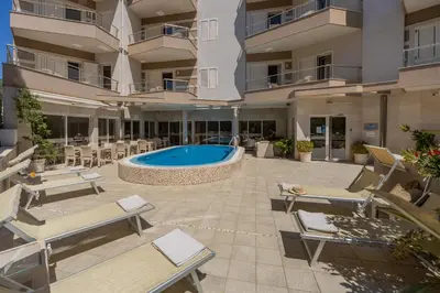 an external view of a building with a swimming pool at Apartments Del Mar in Petrovac na Moru
