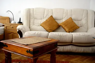 a living room with a couch and a coffee table at Hotel Sanja former Oliva in Budva