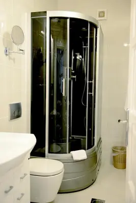 a bathroom with a shower with a toilet and a sink at Hotel Sanja former Oliva in Budva