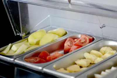a tray filled with tomatoes and other vegetables at Hotel Sanja former Oliva in Budva