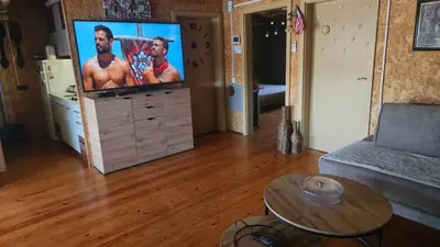 a living room with a flat screen tv on a dresser at Lola - Ada Bojana River House in Ulcinj