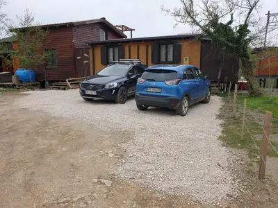 two cars parked in front of a house at Lola - Ada Bojana River House in Ulcinj
