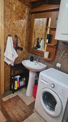 a bathroom with a washing machine and a sink at Lola - Ada Bojana River House in Ulcinj