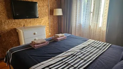 a bedroom with a bed with two towels and a tv at Lola - Ada Bojana River House in Ulcinj