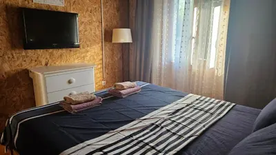 a bedroom with a bed with a tv on the wall at Lola - Ada Bojana River House in Ulcinj