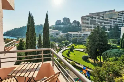 a balcony with a view of a park and buildings at Iberostar Waves Bellevue All Inclusive in Budva