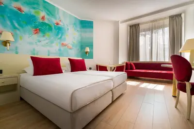 a hotel room with a bed and a couch at Iberostar Waves Bellevue All Inclusive in Budva
