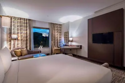a hotel room with a bed and a television at Hilton Podgorica Crna Gora in Podgorica