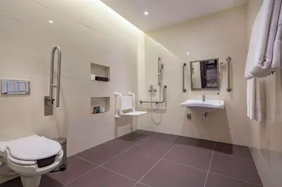 a bathroom with a toilet and a sink at Hilton Podgorica Crna Gora in Podgorica