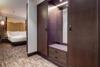 a bathroom with a mirror and a bed in a room at Hilton Podgorica Crna Gora in Podgorica
