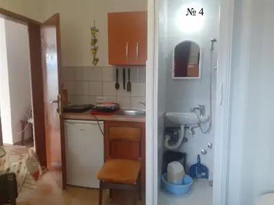 a small kitchen with a sink and a mirror at OLGA apartmani in Sutomore