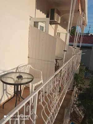 a balcony with a table and a table at OLGA apartmani in Sutomore