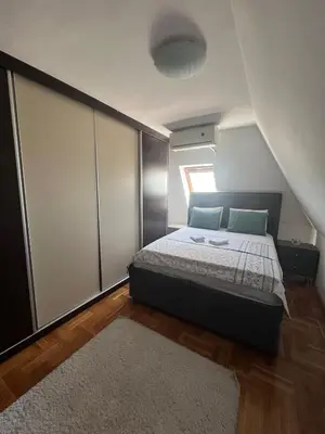 a small bedroom with a bed and a window at Stan u strogom centru grada in Podgorica