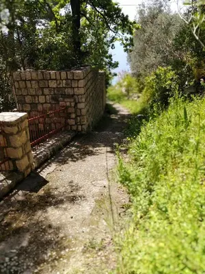 a brick wall next to a dirt road at Villa Golda, The whole house Biker Friendly in Rijeka Reževići