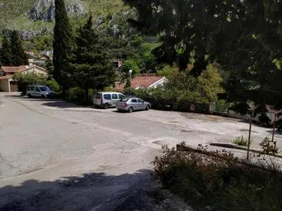 a parking lot with two cars parked on the street at Villa Golda, The whole house Biker Friendly in Rijeka Reževići