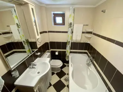 a bathroom with a sink and a tub and a toilet at Villa Golda, The whole house Biker Friendly in Rijeka Reževići