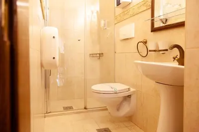 a bathroom with a shower and a toilet and a sink at Casa Antica Druško in Kotor