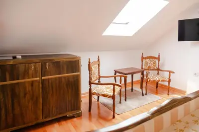 a dining room with a table and two chairs at Casa Antica Druško in Kotor