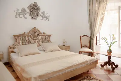 a bedroom with a large bed and a table at Casa Antica Druško in Kotor