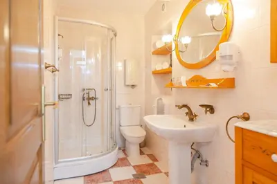 a bathroom with a shower toilet and a sink at Casa Antica Druško in Kotor