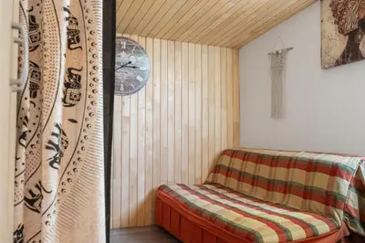 a room with a sauna with a bench and a clock at Orange Apart in Ulcinj