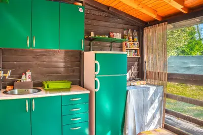a kitchen with green cabinets and a refrigerator at Orange Apart in Ulcinj
