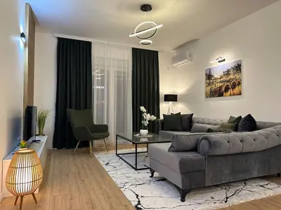 a living room with a couch and a table at Swiss Apartments 1 in Ulcinj
