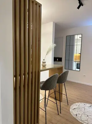 a living room with two chairs and a table at Swiss Apartments 1 in Ulcinj