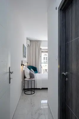 a bedroom with a bed and a table and a door at Marco Polo in Petrovac na Moru