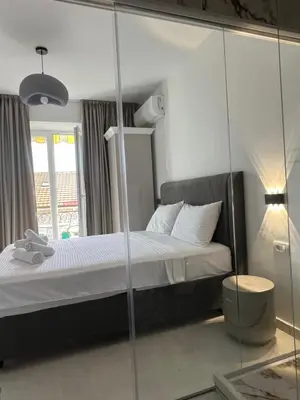 a bedroom with a bed and a mirror at Marco Polo in Petrovac na Moru