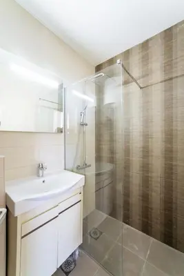 a bathroom with a sink and a glass shower at Budva Gate in Budva