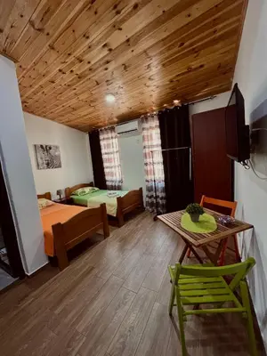 a living room with a bed and a table and chairs at Old Town - Guest House in Stari Bar