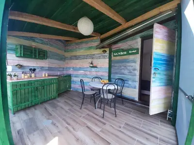 a dining room with a table and chairs at RAINBOW HOME in Gornji Štoj