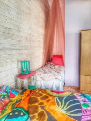 a small room with a bed and a table at RAINBOW HOME in Gornji Štoj